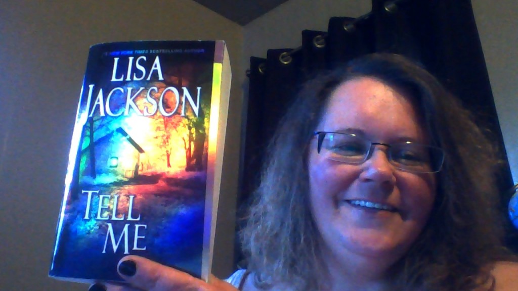 me holding a book I got from author Lisa Jackson