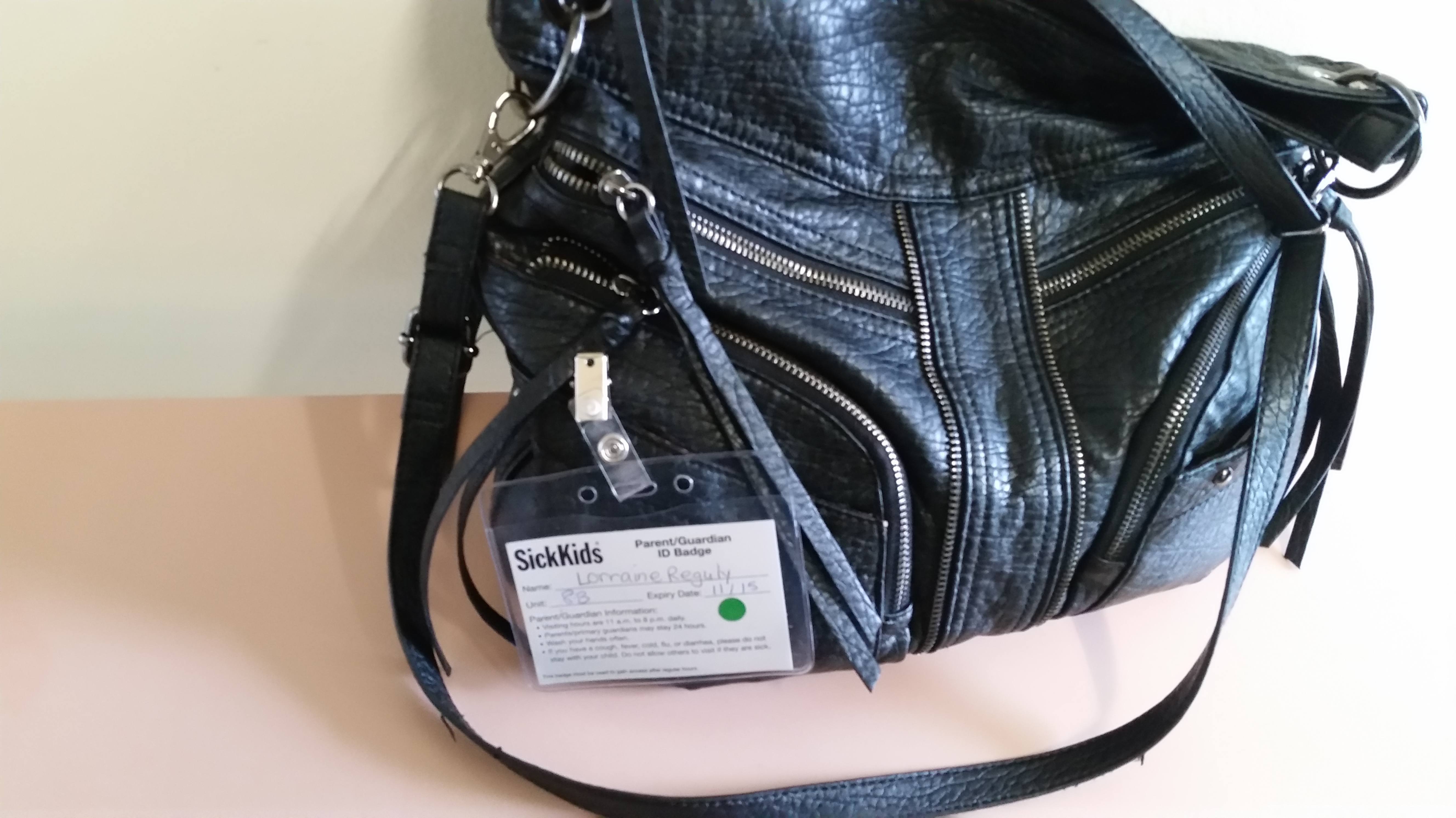 My visitor ID badge attached to my purse