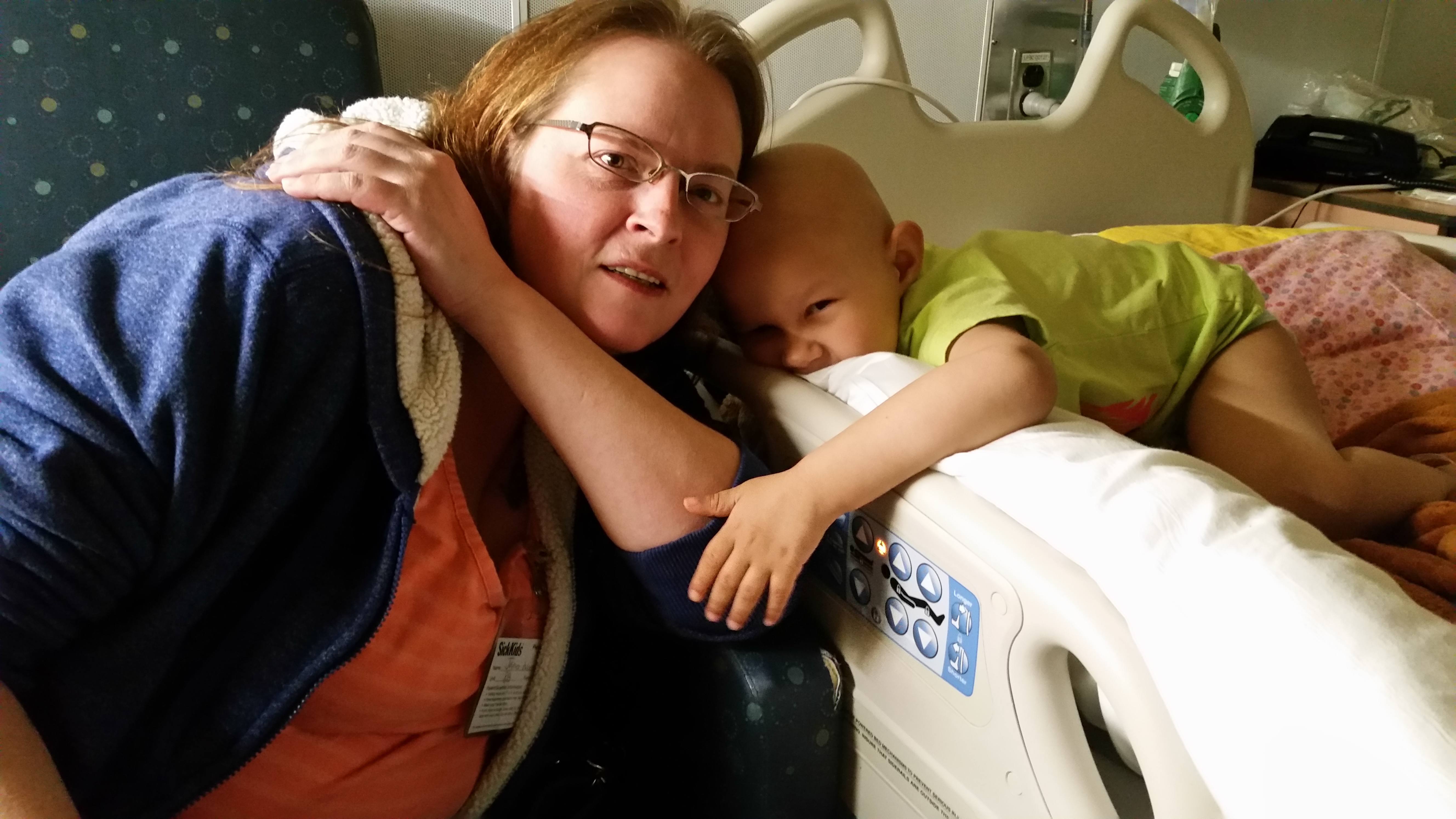 Sam and Janice hugging in the isolation room at SickKids