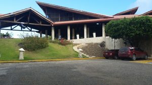 the parking lot of the hotel with the hotel entrance in the background